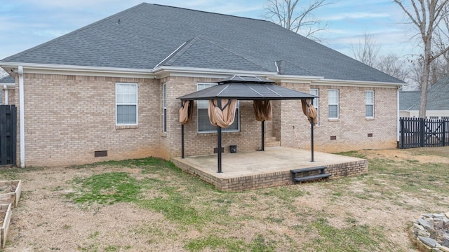 back of house with a lawn, a patio area, and a gazebo