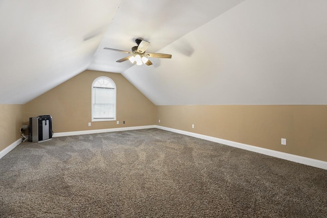 additional living space with carpet floors and vaulted ceiling