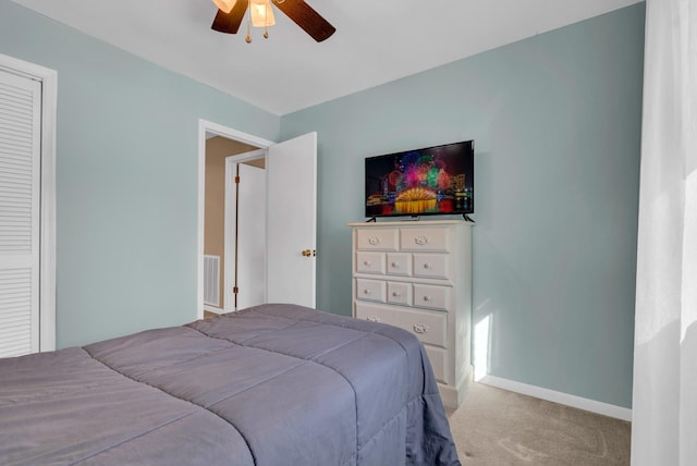 carpeted bedroom featuring a closet and ceiling fan