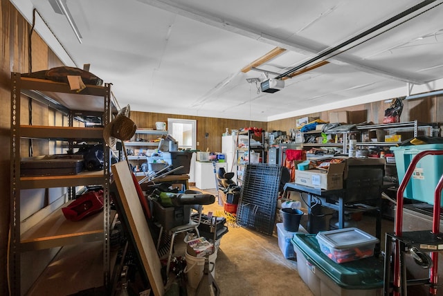 garage featuring a garage door opener and wood walls