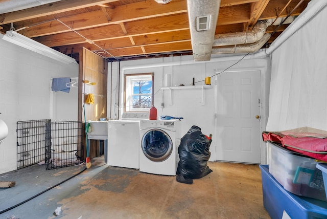 clothes washing area featuring sink and washer and dryer