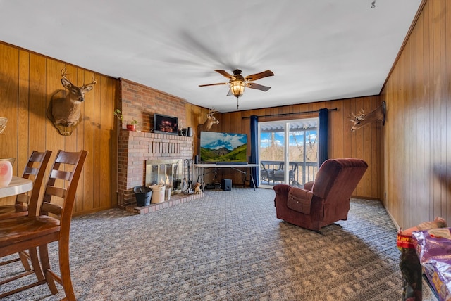 carpeted living room with a brick fireplace and ceiling fan