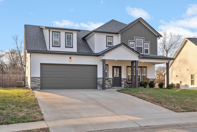 view of front of property featuring a garage, a front yard, a porch, and central AC