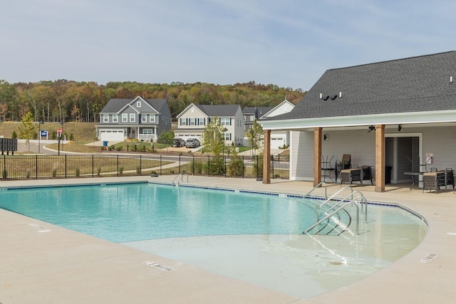 view of swimming pool featuring a patio and ceiling fan