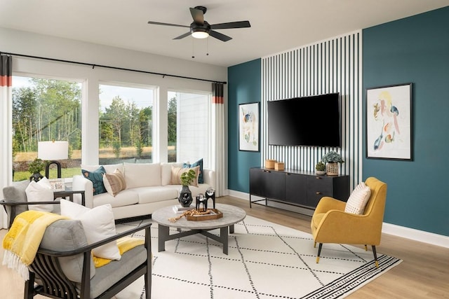 living room with light wood-type flooring and ceiling fan