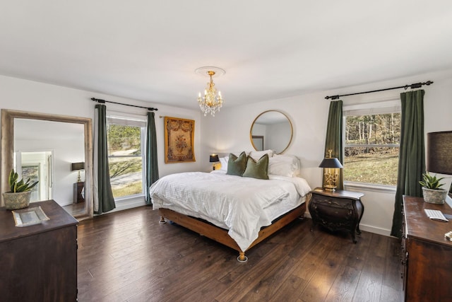 bedroom featuring dark hardwood / wood-style flooring and a chandelier