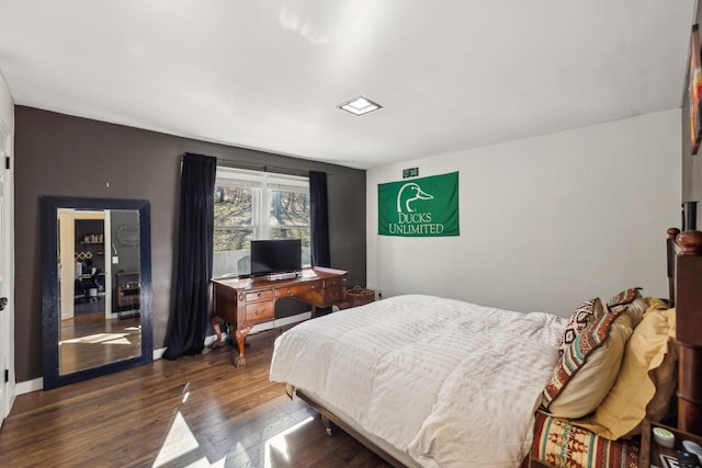 bedroom featuring dark hardwood / wood-style flooring