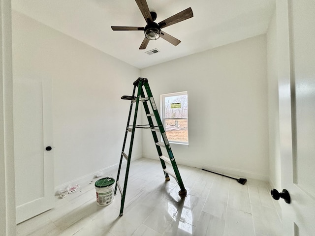 exercise room with ceiling fan