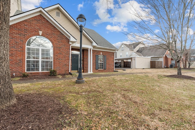 exterior space with central AC unit and a yard