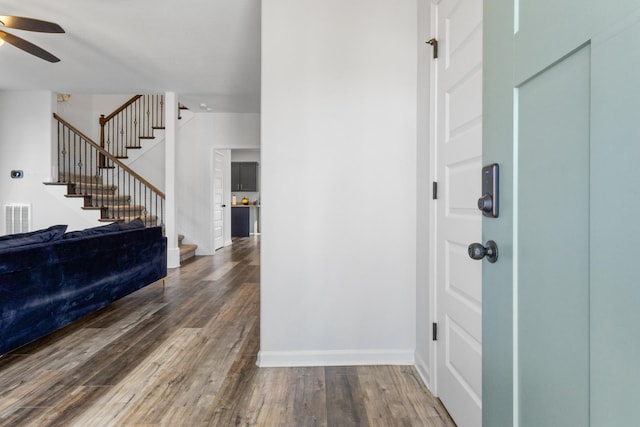 foyer featuring ceiling fan and dark hardwood / wood-style floors