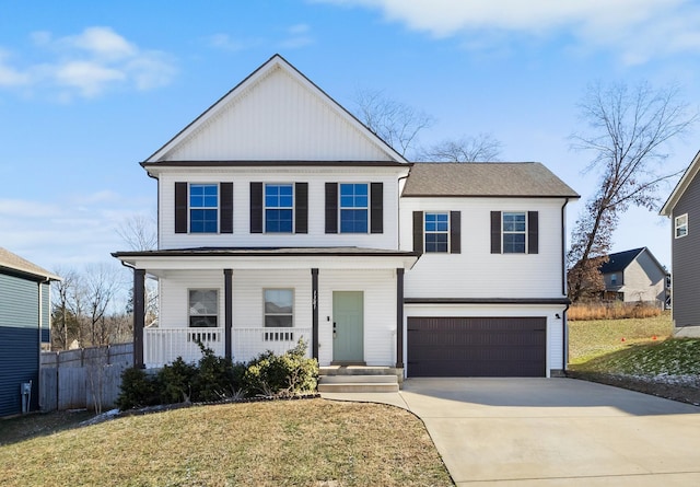 view of front of property with a porch, a garage, and a front lawn