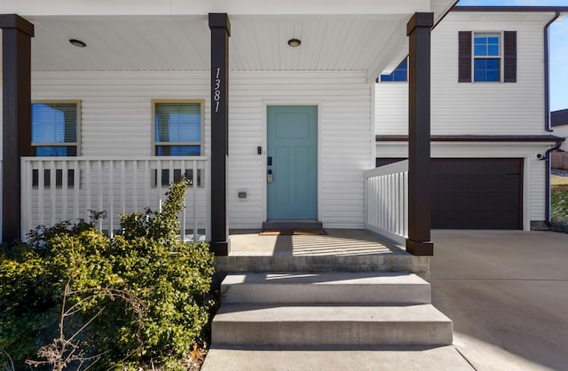 doorway to property with a garage and covered porch