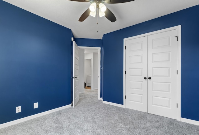 unfurnished bedroom featuring light carpet, a closet, and ceiling fan