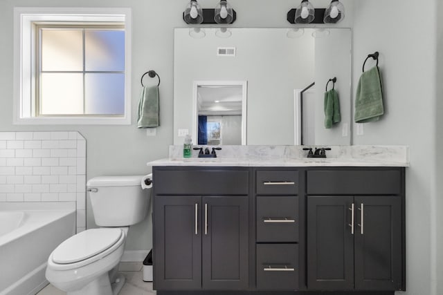 bathroom featuring a tub, toilet, and vanity