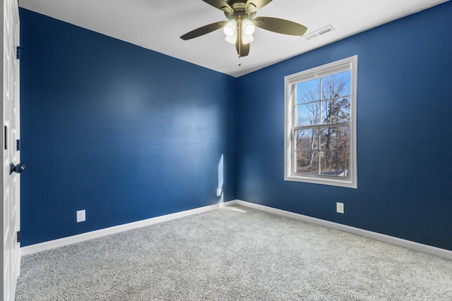 spare room featuring ceiling fan and carpet