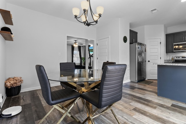 dining space featuring an inviting chandelier and dark hardwood / wood-style floors