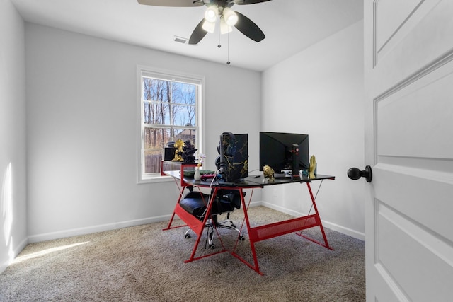 carpeted home office with ceiling fan