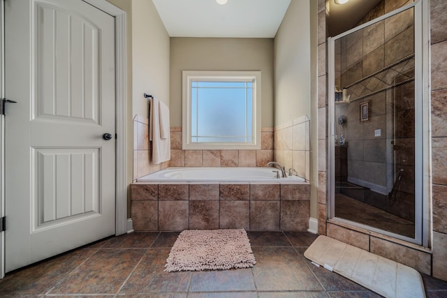 bathroom featuring separate shower and tub