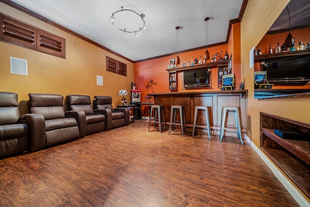 bar featuring crown molding, hardwood / wood-style floors, a fireplace, and hanging light fixtures