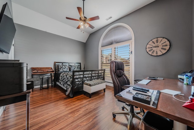 bedroom featuring ceiling fan, lofted ceiling, and hardwood / wood-style flooring