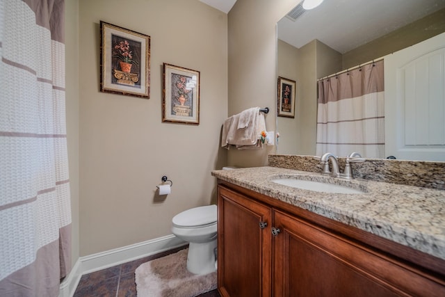 bathroom with toilet, walk in shower, and vanity