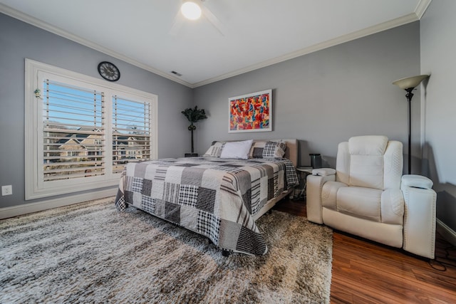 bedroom featuring ceiling fan, dark hardwood / wood-style flooring, and ornamental molding