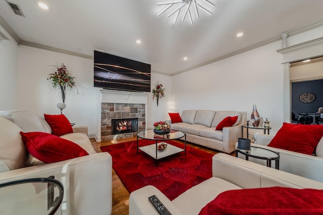 living room featuring wood-type flooring, ornamental molding, and a fireplace