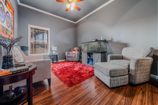 sitting room with ceiling fan, ornamental molding, dark wood-type flooring, and lofted ceiling