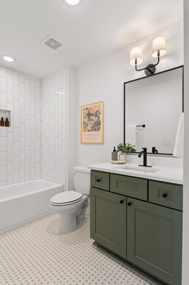 full bathroom featuring tiled shower / bath combo, toilet, and vanity