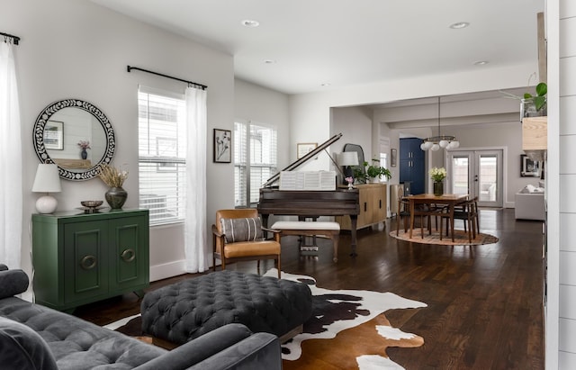 living room featuring french doors, a wealth of natural light, and dark wood-type flooring