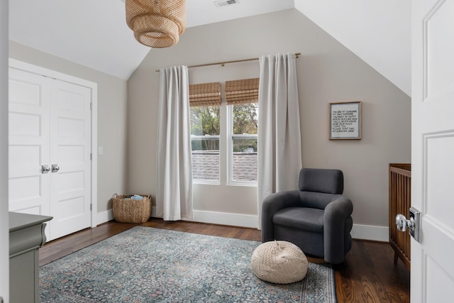 living area with dark hardwood / wood-style flooring and vaulted ceiling