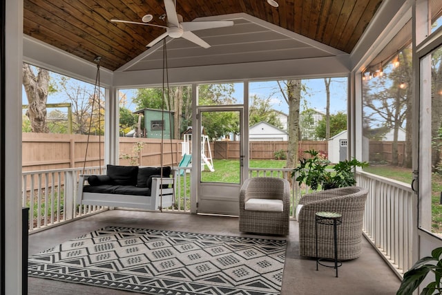 unfurnished sunroom with ceiling fan, wooden ceiling, and lofted ceiling