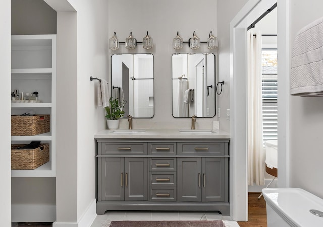 bathroom with vanity and a tub to relax in