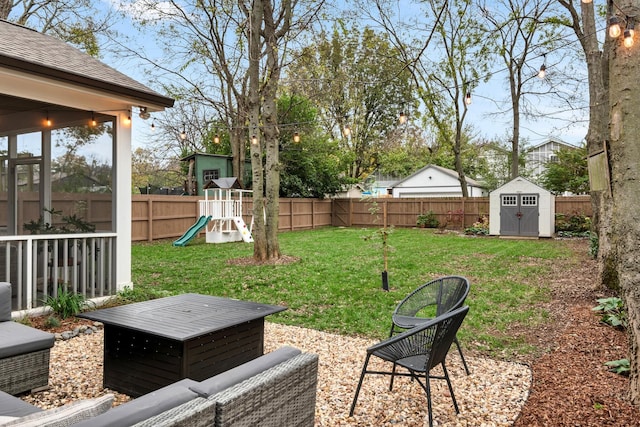 view of yard with a playground and a storage unit