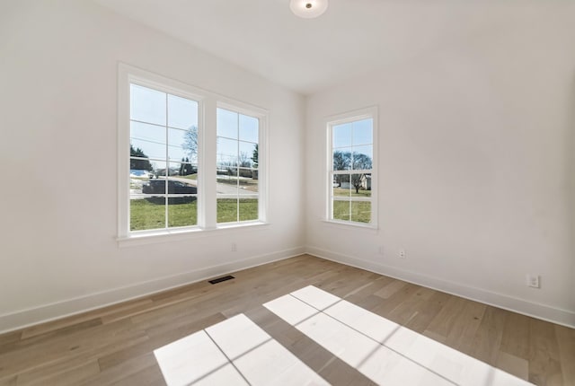 spare room featuring light hardwood / wood-style floors