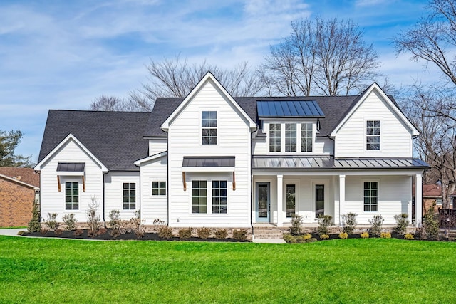 view of front of home with covered porch and a front yard