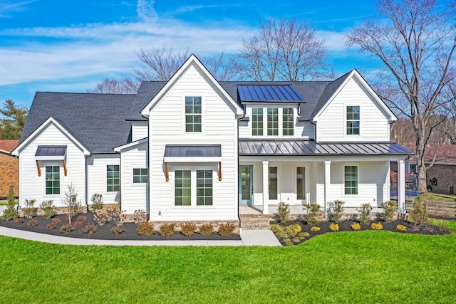 modern farmhouse with a porch and a front yard