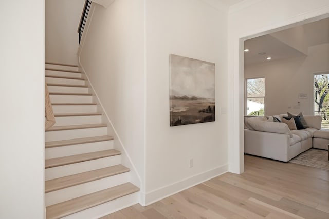 staircase featuring hardwood / wood-style flooring and ornamental molding