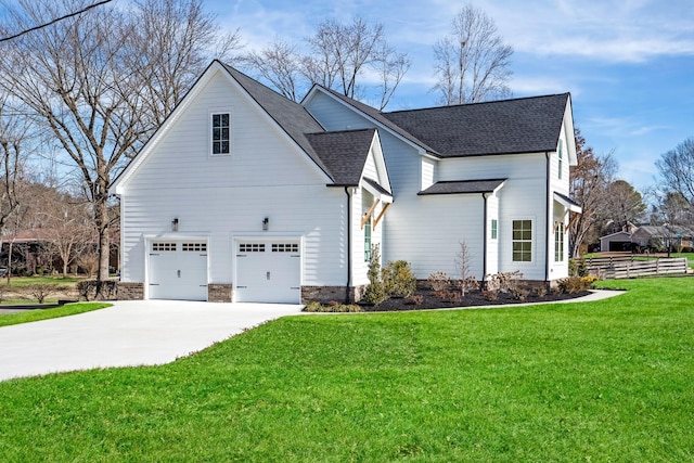 view of side of property featuring a garage and a yard