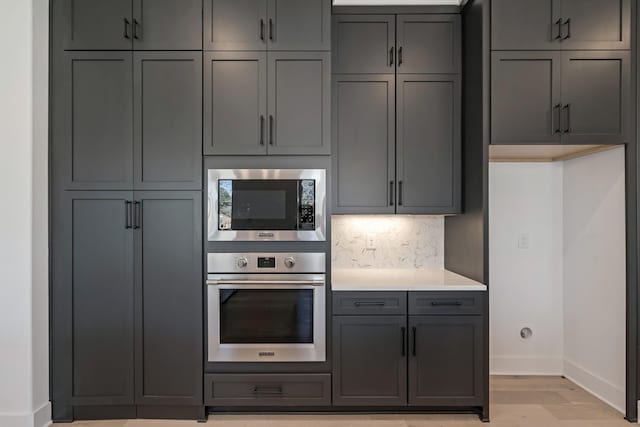 kitchen with light hardwood / wood-style floors, gray cabinetry, and stainless steel appliances