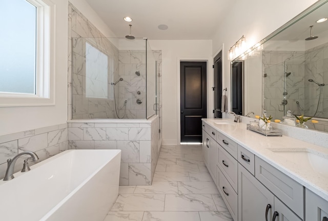 bathroom featuring independent shower and bath, plenty of natural light, and vanity