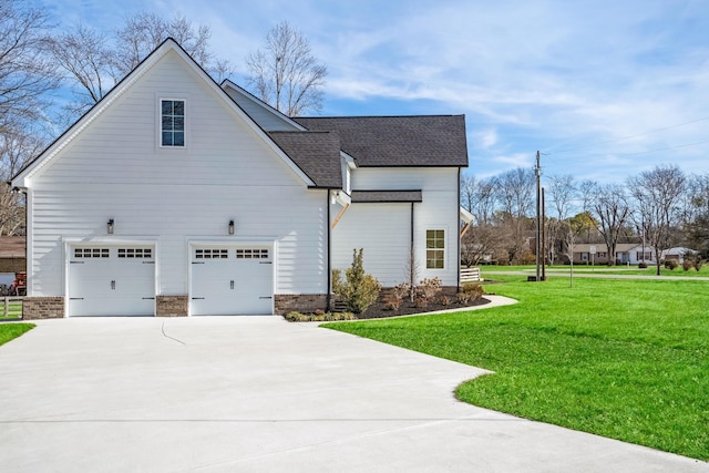 view of home's exterior with a garage and a lawn