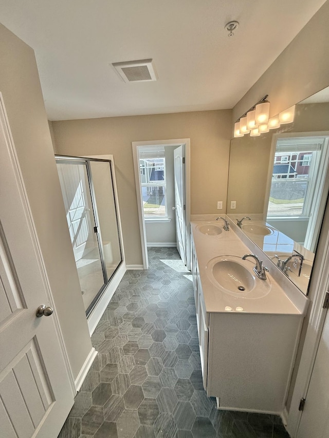 bathroom featuring walk in shower and vanity