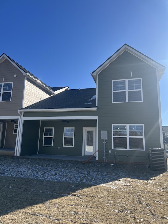 rear view of property with a patio and central AC