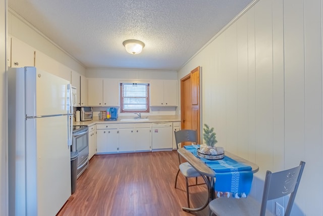 kitchen featuring white cabinetry, white appliances, dark hardwood / wood-style floors, and crown molding