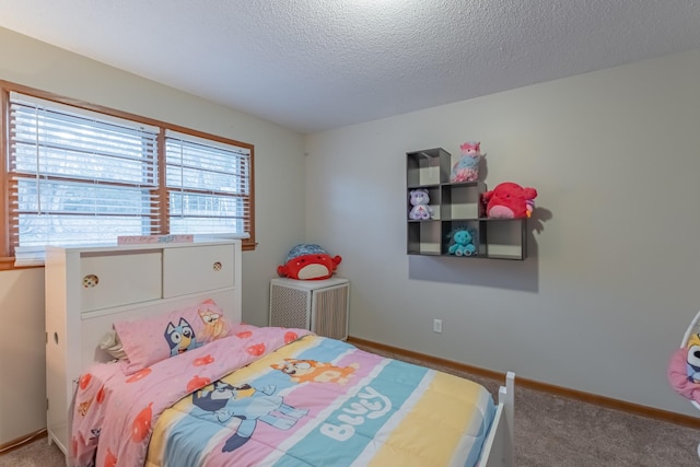 bedroom featuring carpet flooring and a textured ceiling