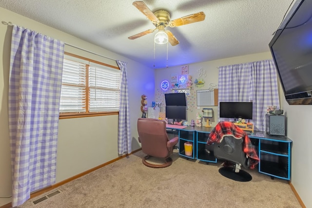 playroom with ceiling fan, carpet flooring, and a textured ceiling