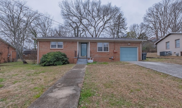 view of front of property featuring a garage, central air condition unit, and a front yard