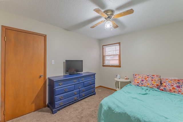 bedroom with light carpet, a textured ceiling, a closet, and ceiling fan