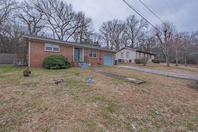 single story home with a garage and a front lawn